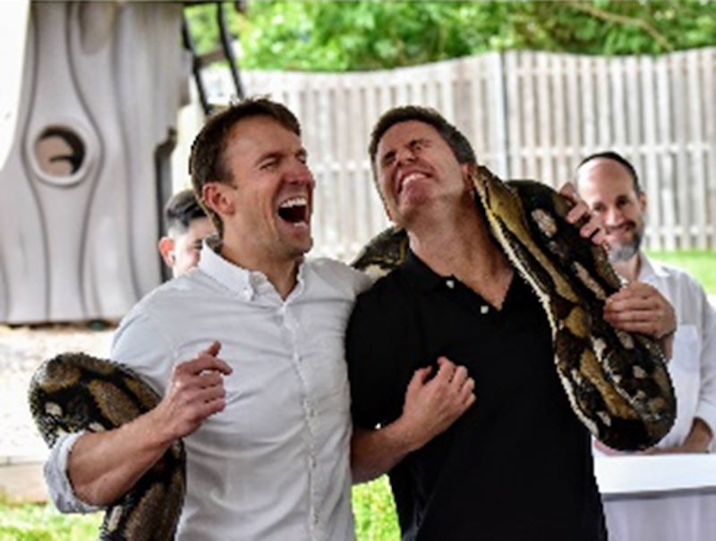 Dave and Mendy enjoying an earful from an 18-foot python
